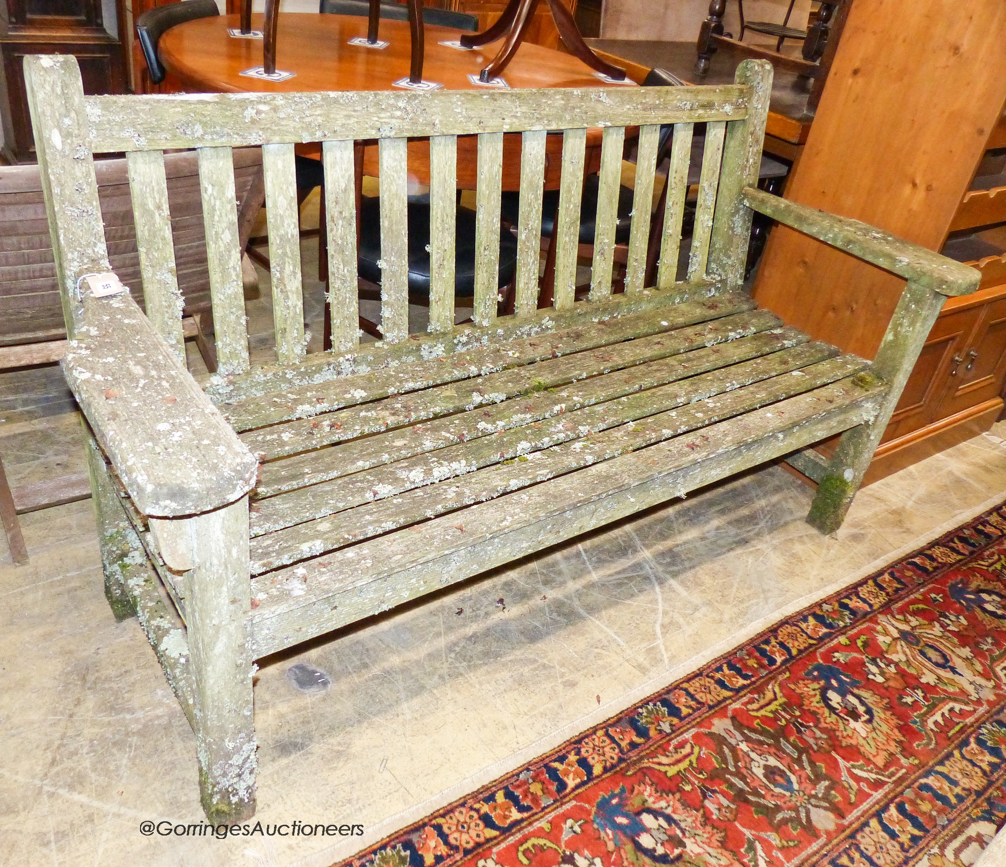 A weathered teak garden bench, length 160cm, depth 56cm, height 90cm